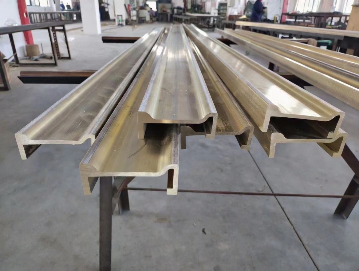 Extruded brass architectural profile installed in modern building project